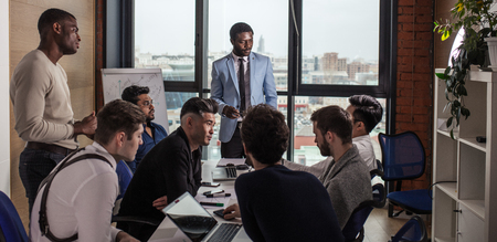 African Chief Executive represents new team member to multiracial coworkersの写真素材