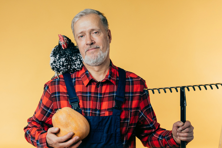 old handsome farmer is looking to the cameraの写真素材