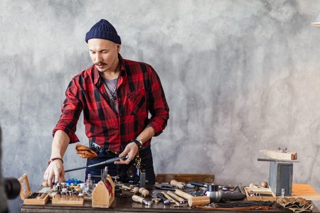 young man choosing the material for repaaring the item. close up photo. copy spaceの写真素材