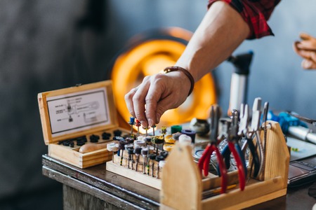 man holding polishing tools at workplace. close up cropped photoの写真素材