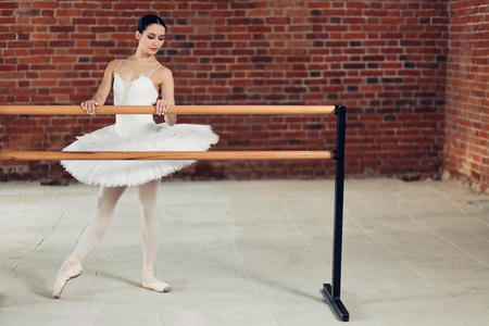 young attractive girl working out with barre in the dance studio, full length photo. copy space. lifestyle, hobbyの写真素材