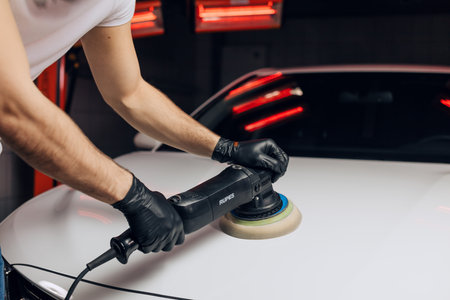 polishing a car hood. close up photo. man creating a brand new look