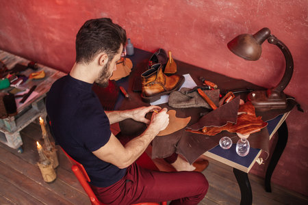 special method of making shoes. top angle view .man taking part in a shoe design course