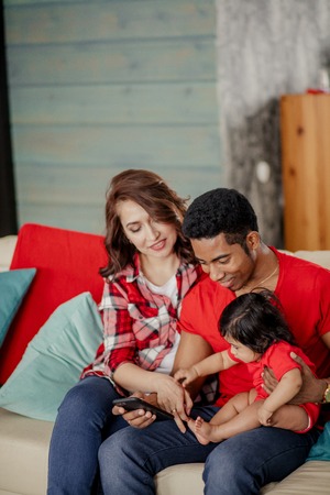 little cute girl wants to take her daddys phone, close up photo. gadget concept. the influence of smart phones , addictionの写真素材