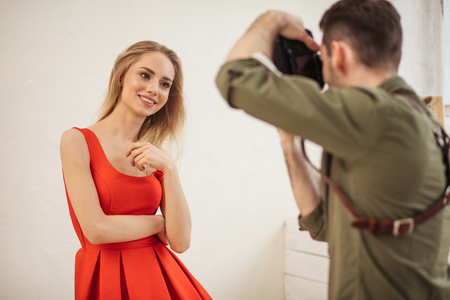 lovely model poses for a photographer at a studio, close up photo. islolated white backgroundの写真素材
