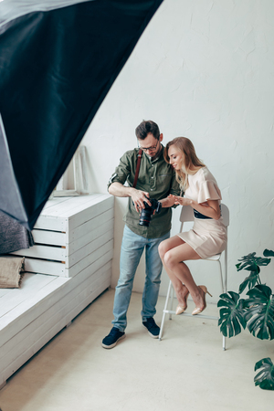 young couple solving a problem with a camera in the studioの写真素材
