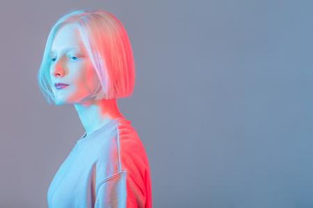 romantic serious girl with perfect skin looking down, close up side view photo, copy space, offence, thoughtの写真素材