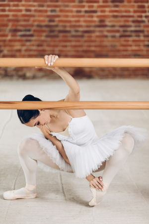 young ballerina has problems with legs. illness.beautiful dancer spraining her ankle. full length photo, difficulties in dancingの写真素材