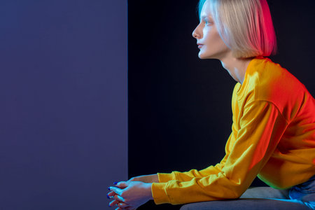 pensive attractive girl having a rest, close up side view photo. thoughtful woman in stylish yellow...