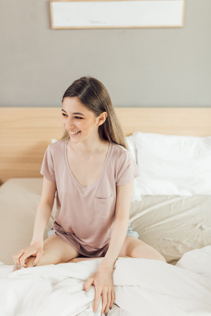 cute positive girl dressed casually, enjoying morning , having fun at home. She has lonf fair hair.new day, happiness, woman expresses positive emotionの写真素材