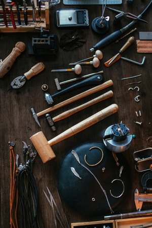 top view photo. of a jeweler artists desk with many suppliesの写真素材