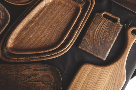 Set of wooden DIY plates, dishes, bowls and trays of different wooden texture, closeup, top view.の写真素材
