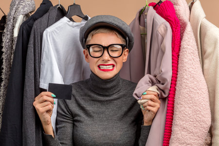 crying girl doesnt have money to buy clothes. close up photo. isolated pink background . sadness, hysterics, negative emotionsの写真素材