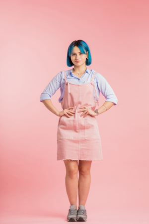 hipster dressed in comfortable casual clothes looking at the camera. extremely popular style. life in pink colorの写真素材