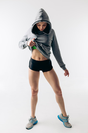 awesome attractive young girl is showing her perfect abs after workout. motivation, ideal body. body acreの写真素材