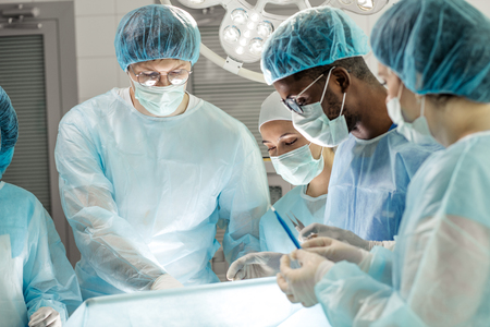 young interns watching the experiment in the hospital. close up photoの写真素材