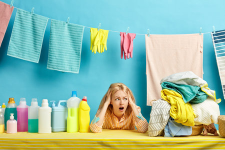 emotional blonde woman is in panic as she doesnt want to wash clothes by hand, he washing machine...
