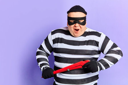 excited happy criminal looking forward to blowing open safe, bank.prisoner wants to burst the door....