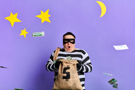 excited awesome fat prisoner throwing money. isolated blue background. studio shot.
