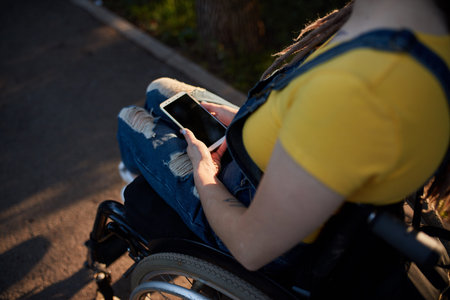 top view of disabled woman reading message on her smartphone.の写真素材
