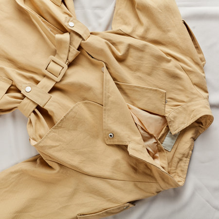 Warm autumn coat lying on the white background. top view photo. sale, business concept