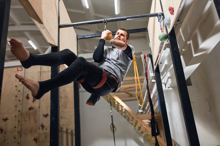Low angle view of physically challenged rock-climber preparing to the international bouldering...