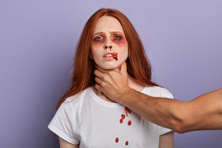 drunk man holding his girlfriend by the throat and threatening her. close up portrait, studio shot....