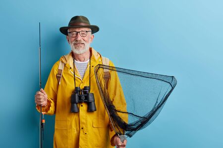 smiling old senior man being enthusiastic about fishing in fresh air, close up photo. copy space. leisureの写真素材