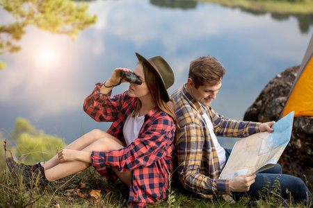 romantic couple having rest on the bank of the river, watcging beautiful nature. close up side view...