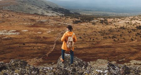 ambitious active tourist exploring nature, back view full length photo. healthy lifestyle, wild lifeの写真素材