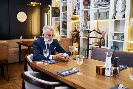 Elegant greybeard senior man buy electronic sigarette, testing e-cigarette. Stop smoke in social placesの写真素材