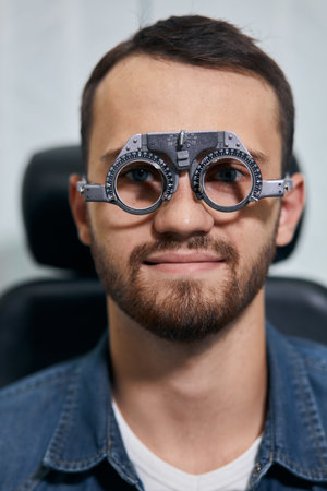 young man checking his eyesight, close up photo. medicine, treatmnet, man preparing for a surgery,...