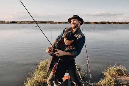 Father teach son how fishing. They have good time.の写真素材