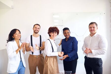 Business for people. African and caucasian business people shake hands each other, friendly partnership, team work. Colleagues applause backgroundの写真素材