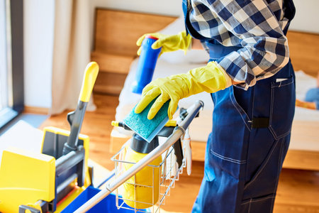 Perfect cleaning by unrecognizable janitor with cleaning equipment, detergents for cleaning bedroom....