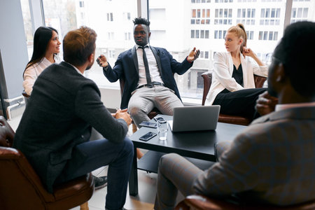 Confident business partners gathered in office to discuss interesting joined business ideas, share...