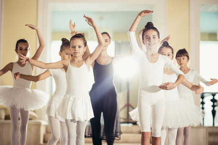 beautiful slim caucasian woman ballerina show how perform ballet dance, taking right pose isolated...