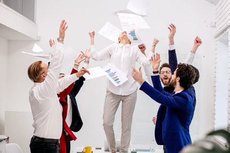 young happy caucasian team celebrate victory in modern office, after successful win or completion of...