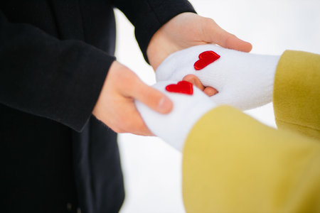 close-up of lovely couple hands. man neatly and reverently hold girlfriend's hands, at winter...
