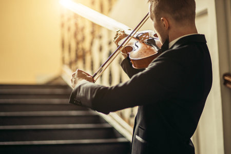 young caucasian talented gorgeous man un tux play violin, professional musician practice...