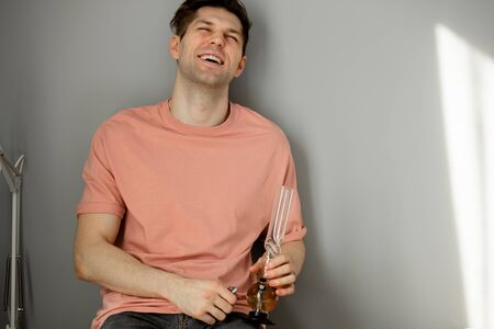 relaxed caucasian man smoke cannabis at home.の写真素材