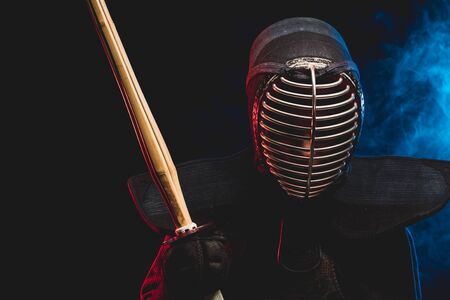 combat warriror, kendo fighter ready to fight using shinai bamboo sword and wearing mask, preparing for competitions. samurai, kendo concept