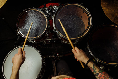 top view on unrecognizable caucasian drummer playing on drum kit. young professional drum player...