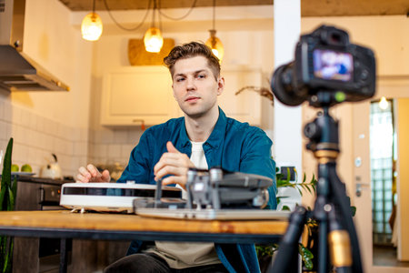 young caucasian blogger man show pros and cons of device at camera, he want to be useful for...