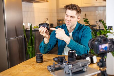 blogging as a habby. blogger and photographer in one face showing different DSLR on camera, unpack and talk about pros, cons, how to use and which is appropriateの写真素材