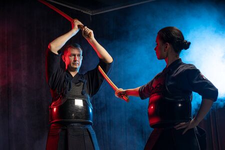 Fight between two caucasian kendo fighters, trainer and pupil sparring on training action. self defense, art exercise concept. traditional warriors skills, samuraiの写真素材
