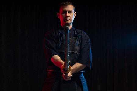 caucasian male kendo fighter with bamboo sword shinai . traditional japanese martial art as hobby....