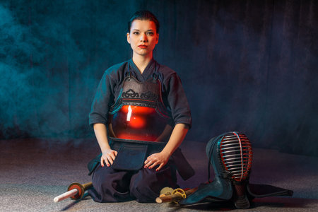 portrait of woman kendo fighter isolated. japanese martial art of sword fighting. strong combat...