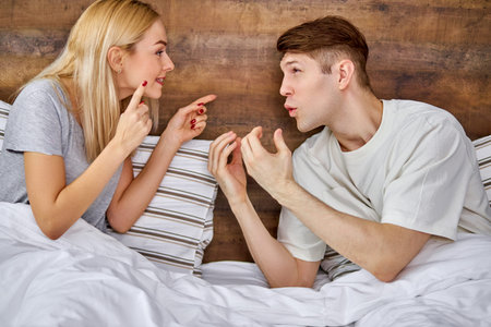 portrait of young caucasian woman chastising husband for his antics, bad behavior, unhealthy...