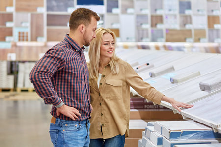 happy young caucasian couple shopping together, they came in the market to make purchase, buy new things for decorating new apartment, enjoyの写真素材